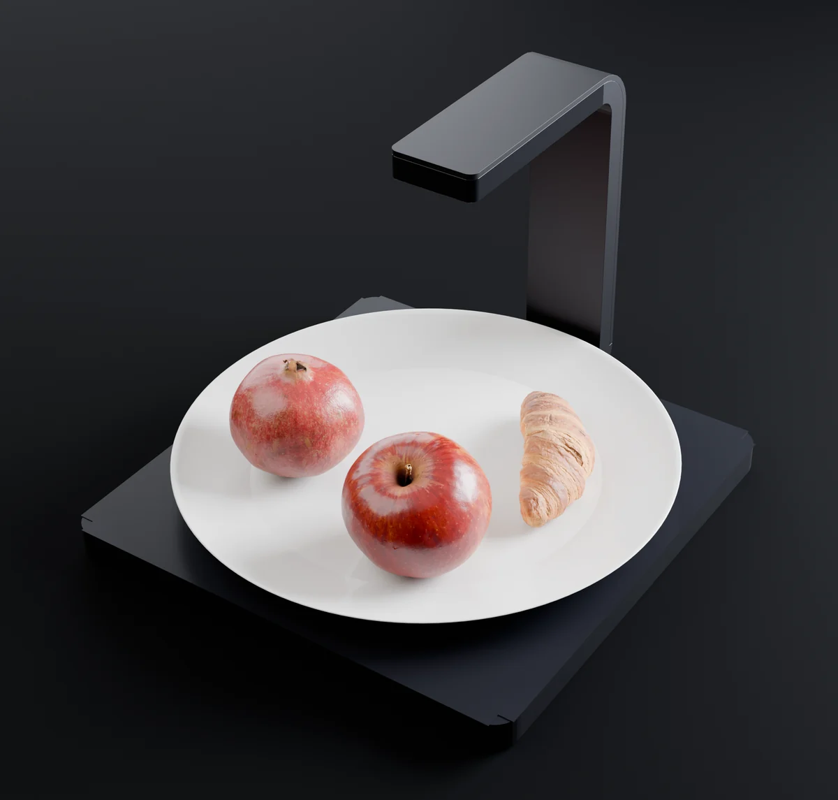 The Calori Scale in space black with an apple, a pomegranate and a croissant on a plate